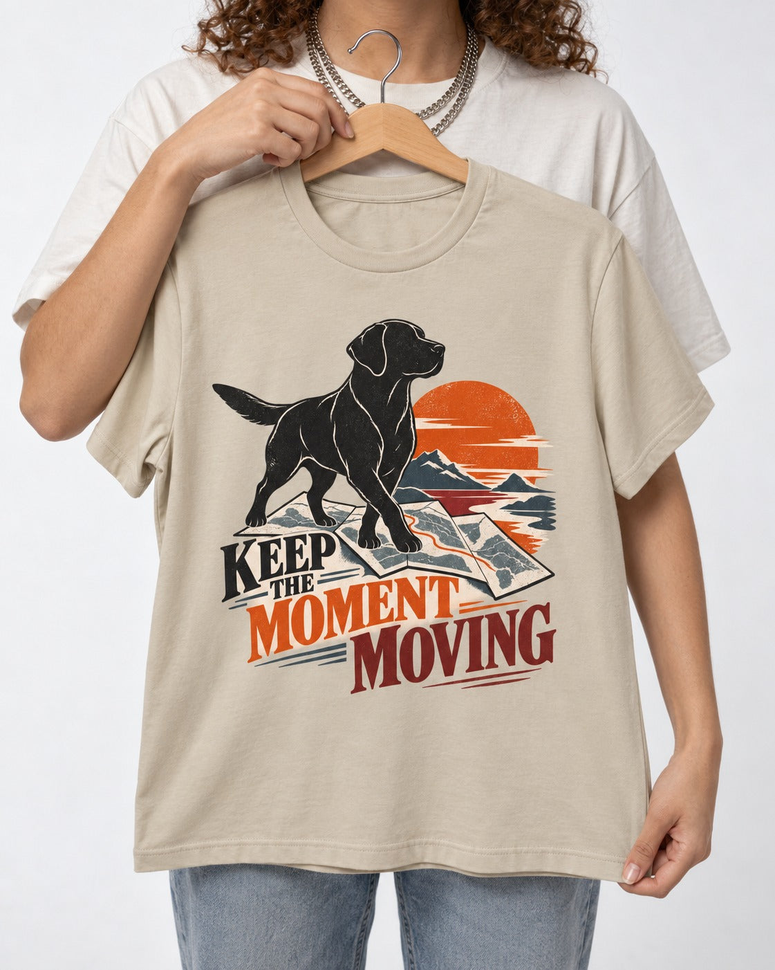 Keep the Moment Moving Labrador Retriever T-Shirt in Sand, held up on a hanger