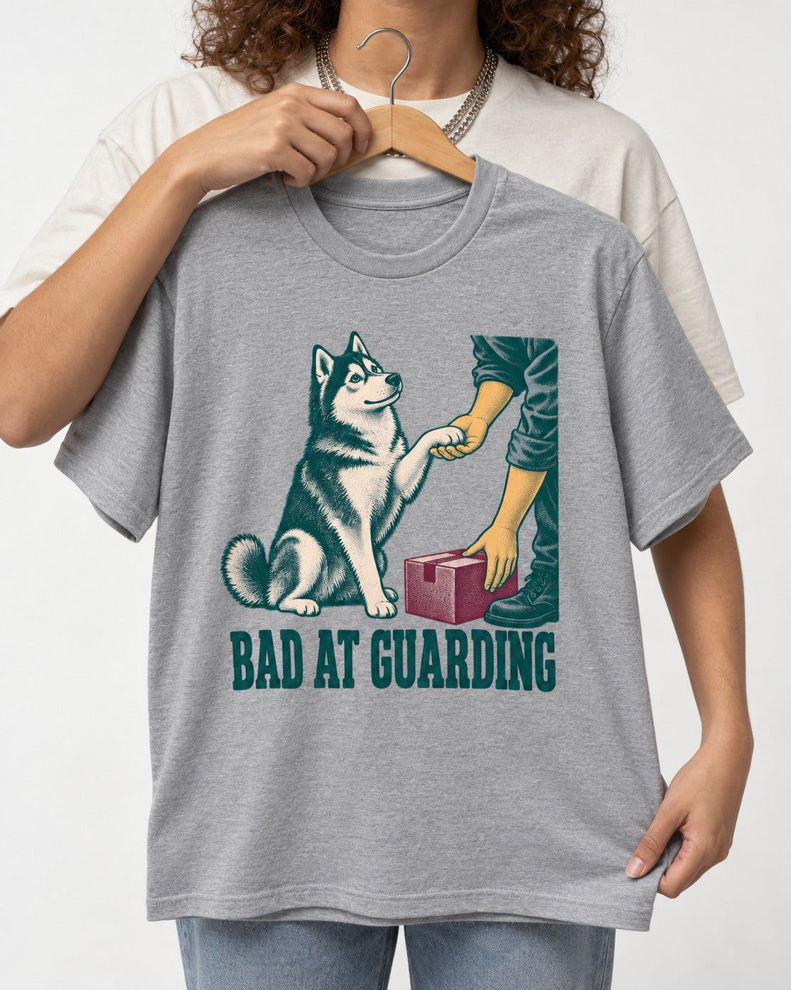 Husky's Bad at Guarding T-Shirt in Sport Grey, held up on a hanger