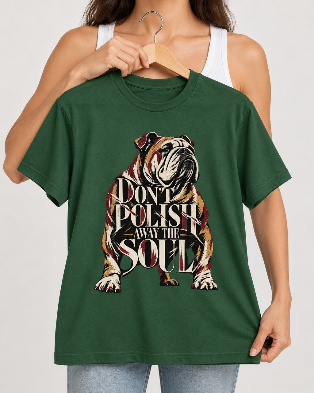 English Bulldog Don't Polish Away the Soul Typography Graphic T-Shirt in Forest Green, held up on a hanger