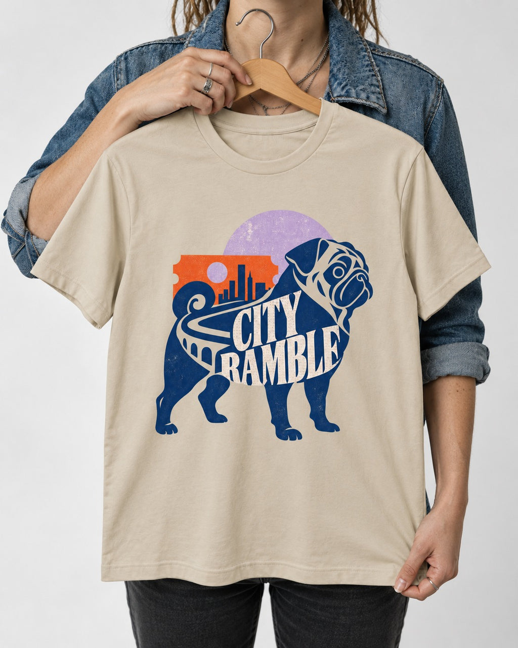 Pug's Big City Ramble T-Shirt in Sand, held up on a hanger