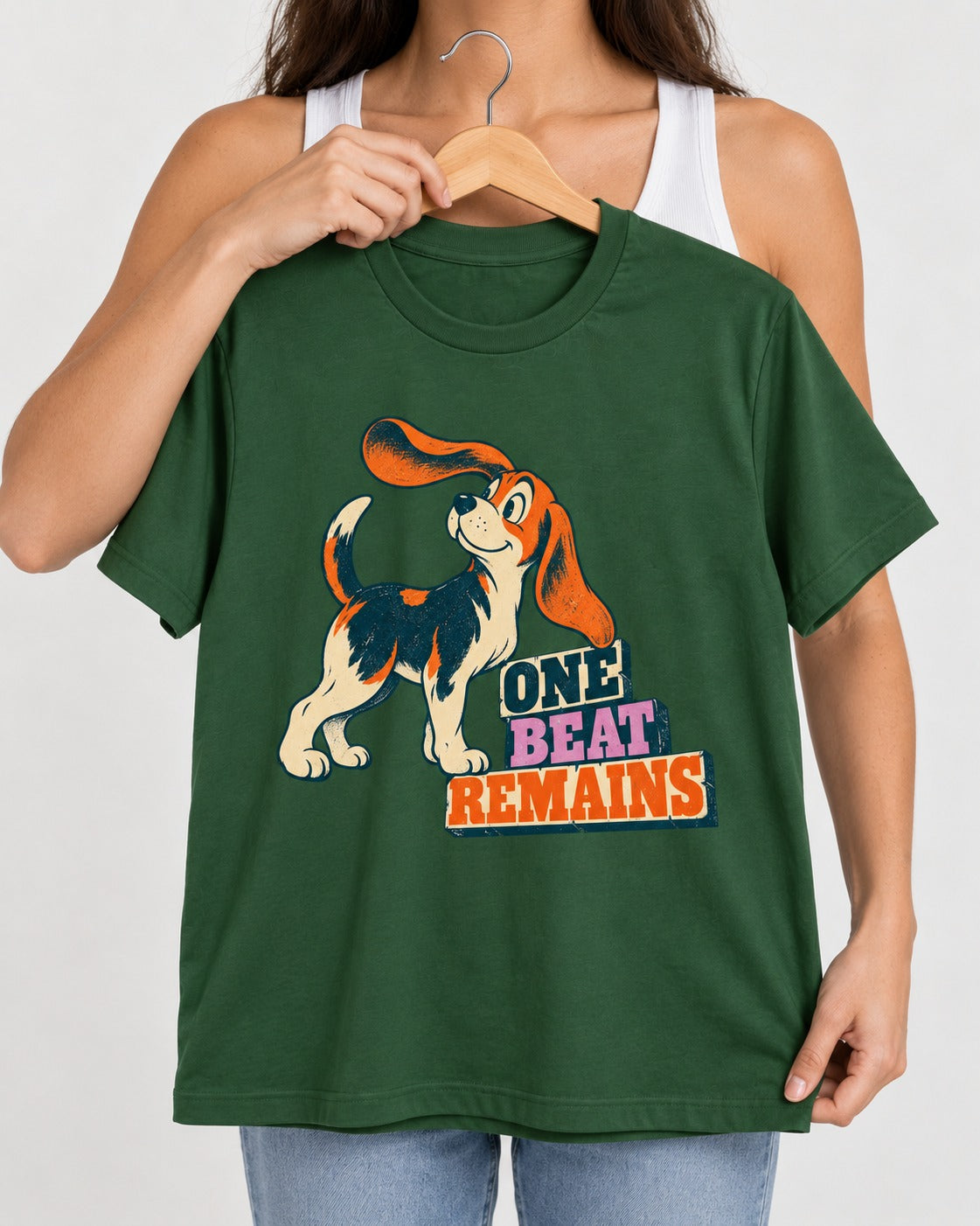 Retro Beagle One Beat Remains T-Shirt in Forest Green, held up on a hanger
