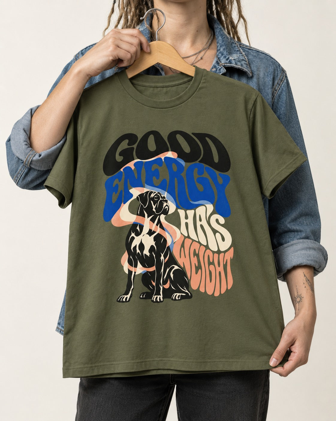 Good Energy Has Weight Boxer Retro Typography T-Shirt in Heather Military Green, held up on a hanger