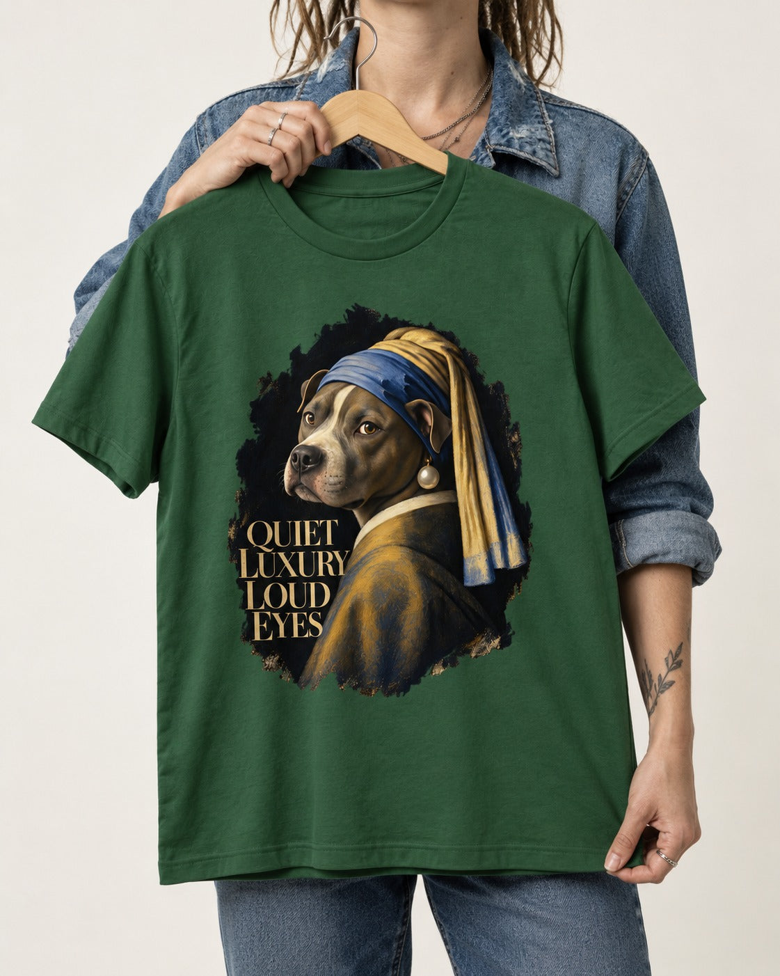 Pitbull Quiet Luxury Loud Eyes Pearl Earring Portrait Graphic T-Shirt in Forest Green, held up on a hanger