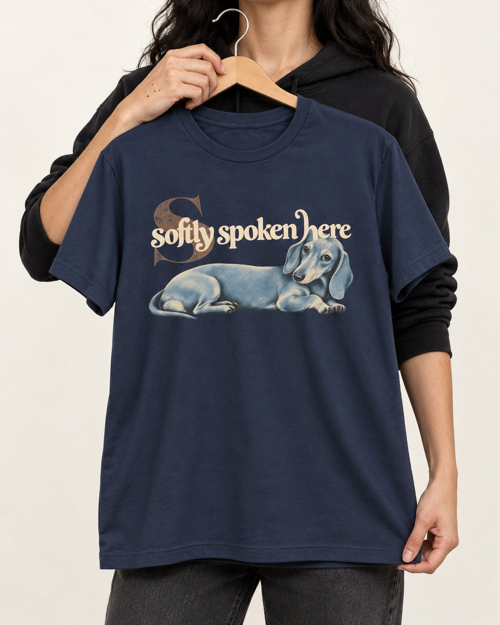 Dachshund Softly Spoken Here Reclining Portrait Graphic T-Shirt in Navy, held up on a hanger