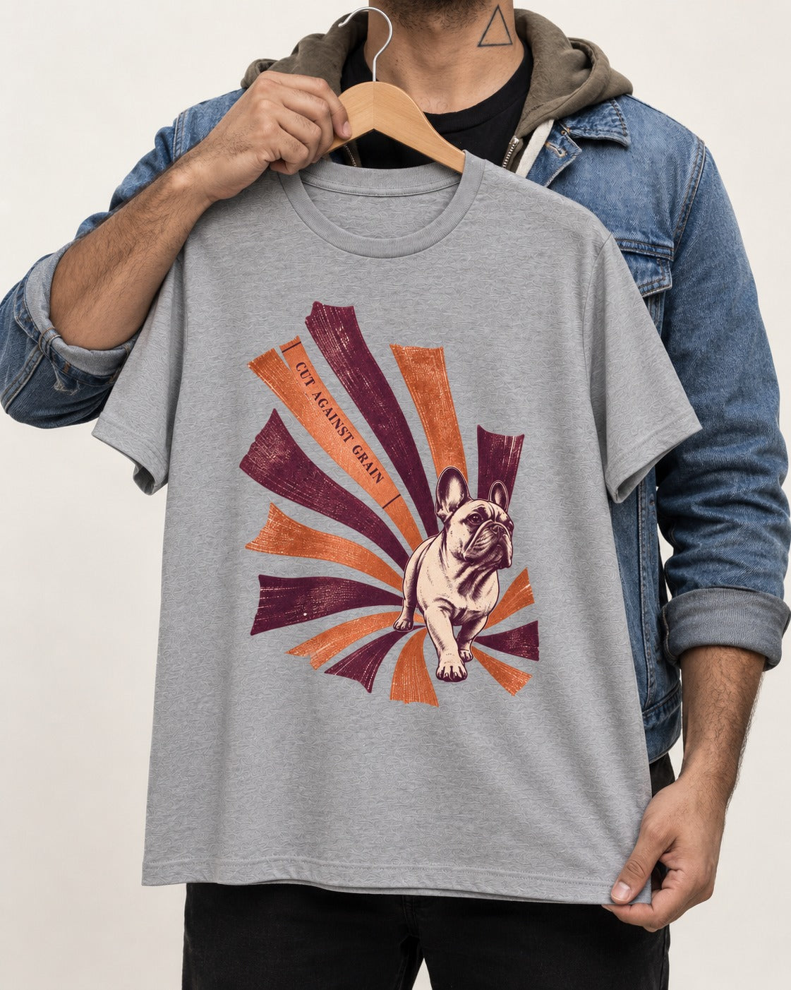 Frenchie Against the Grain T-Shirt in Sport Grey, held up on a hanger