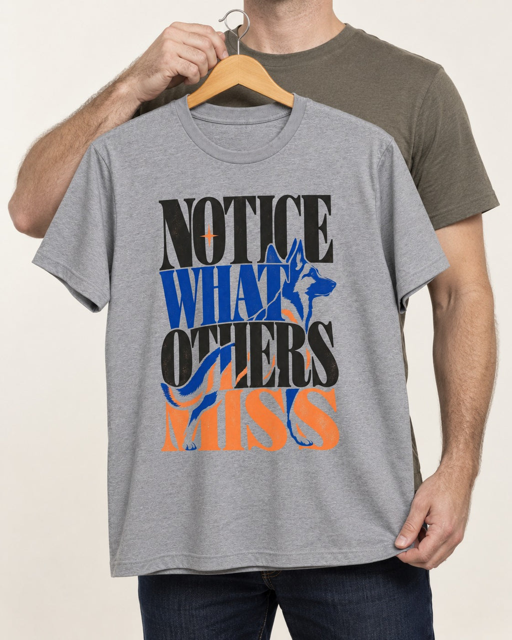 Notice What Others Miss German Shepherd Dog T-Shirt in Sport Grey, held up on a hanger