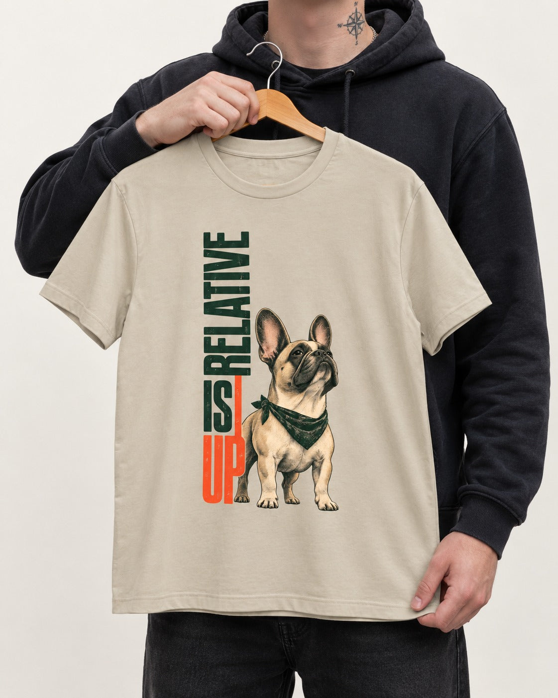 Up Is Relative Frenchie T-Shirt in Sand, held up on a hanger