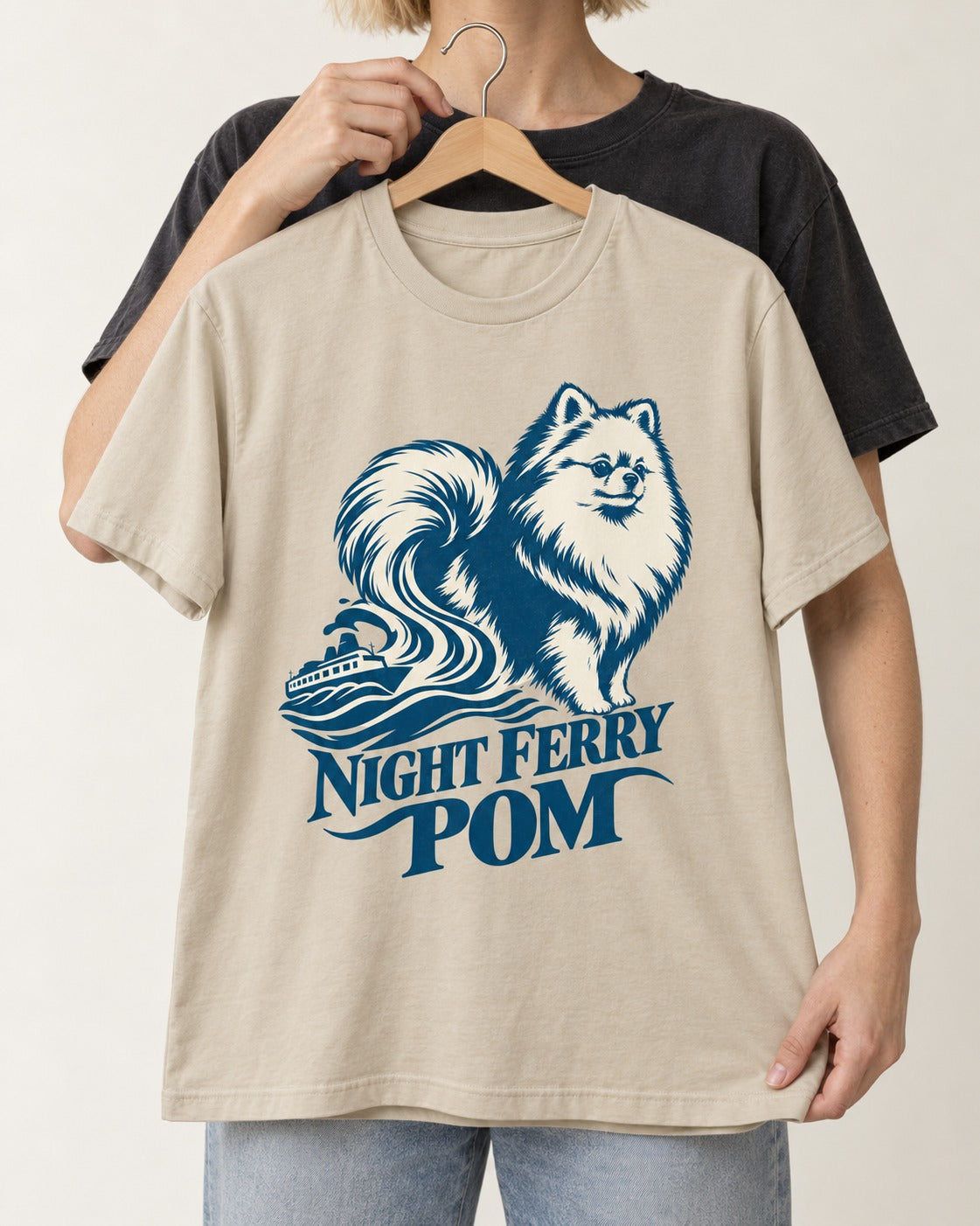 Night Ferry Pomeranian T-Shirt in Sand, held up on a hanger