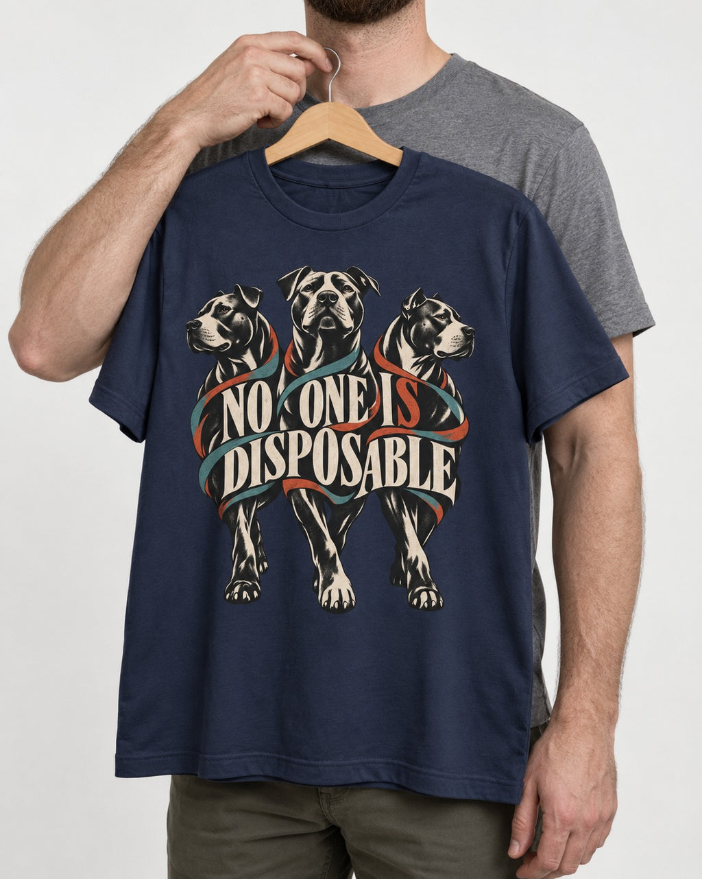 Pitbull No One Is Disposable Three Dogs Graphic T-Shirt in Navy, held up on a hanger