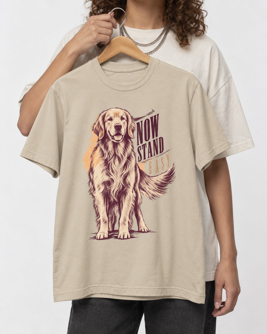 Now Stand Easy Golden Retriever T-Shirt in Sand, held up on a hanger