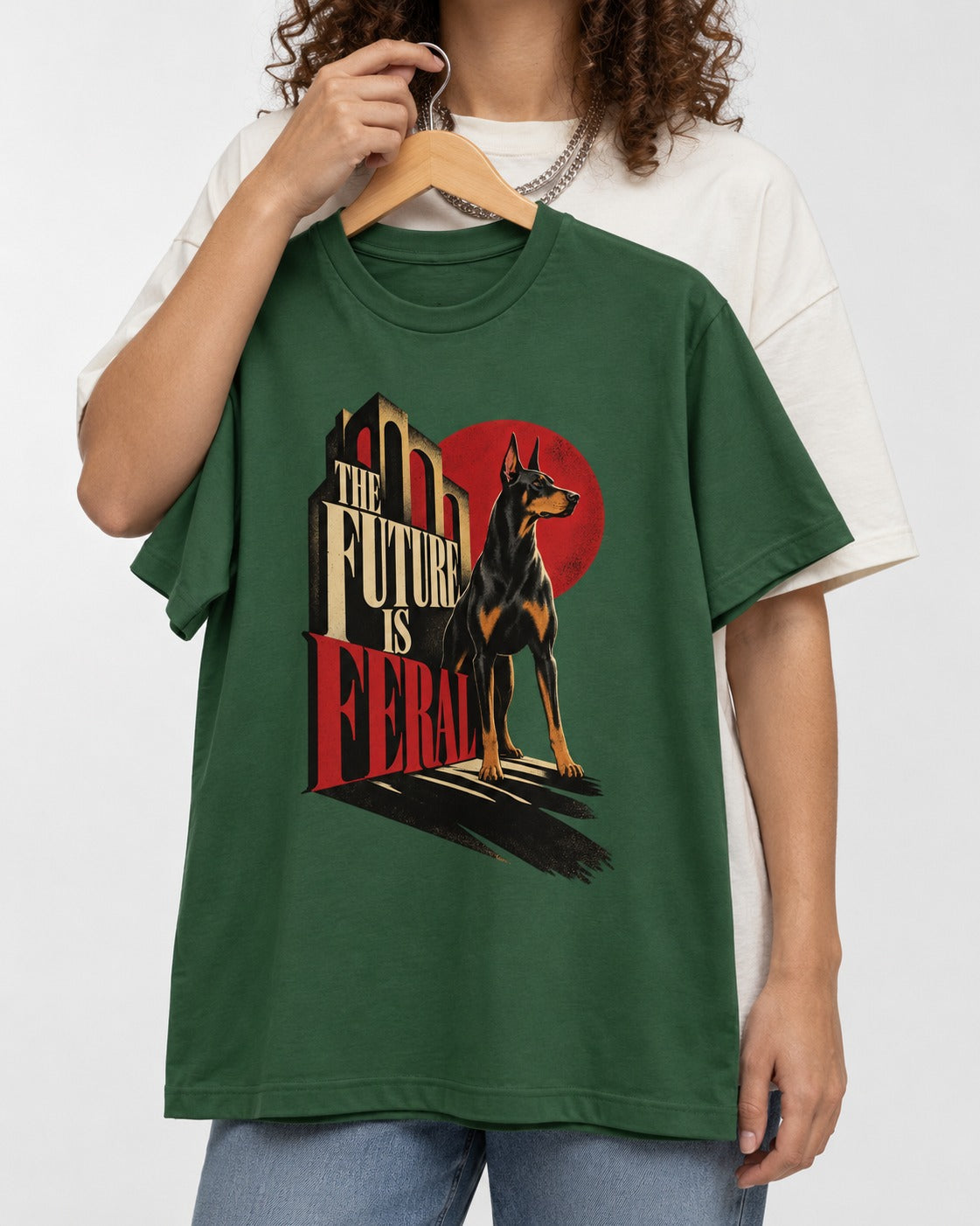 Doberman The Future Is Feral Art Deco Graphic T-Shirt in Forest Green, held up on a hanger