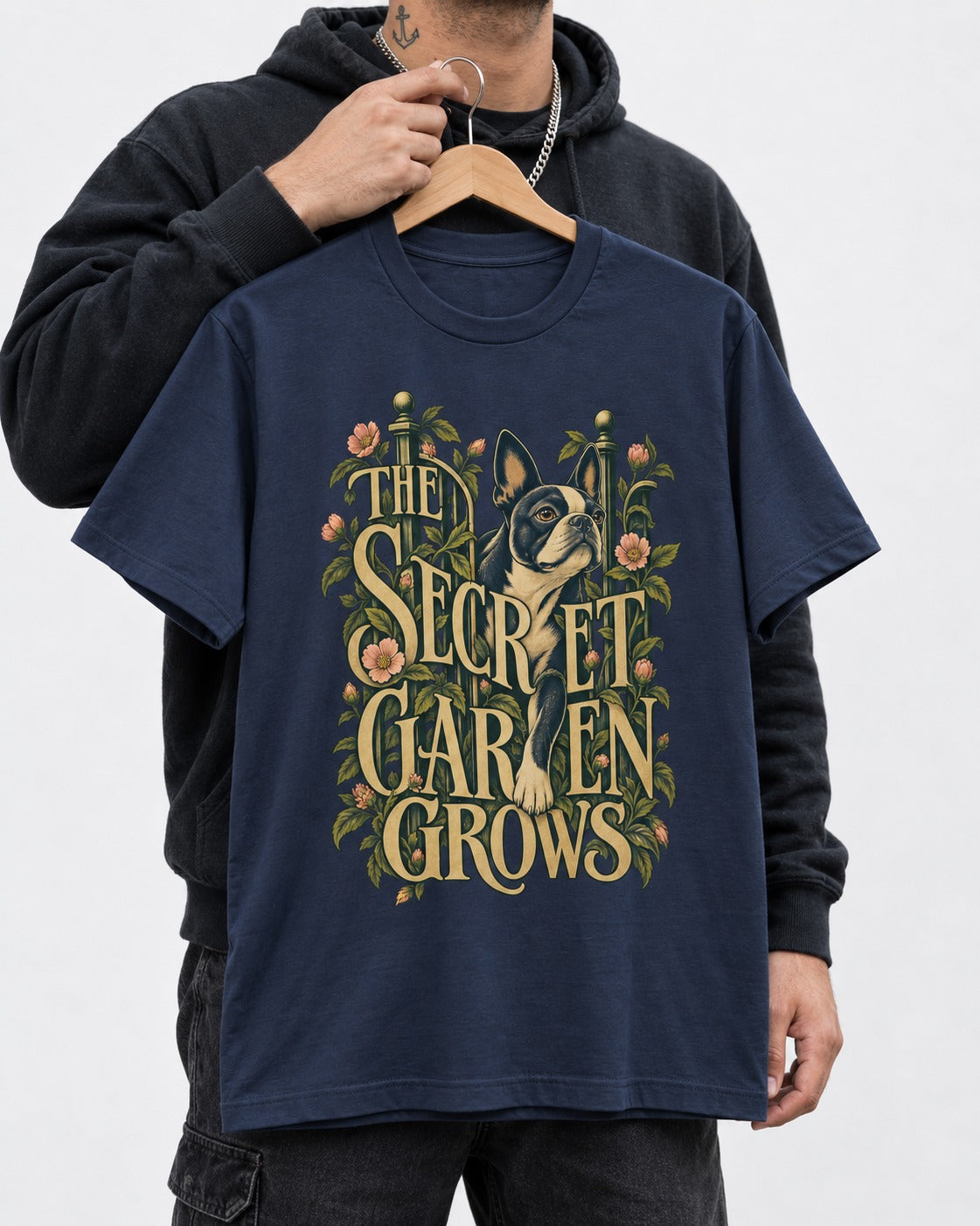 The Secret Garden Grows Boston Terrier T-Shirt in Navy, held up on a hanger