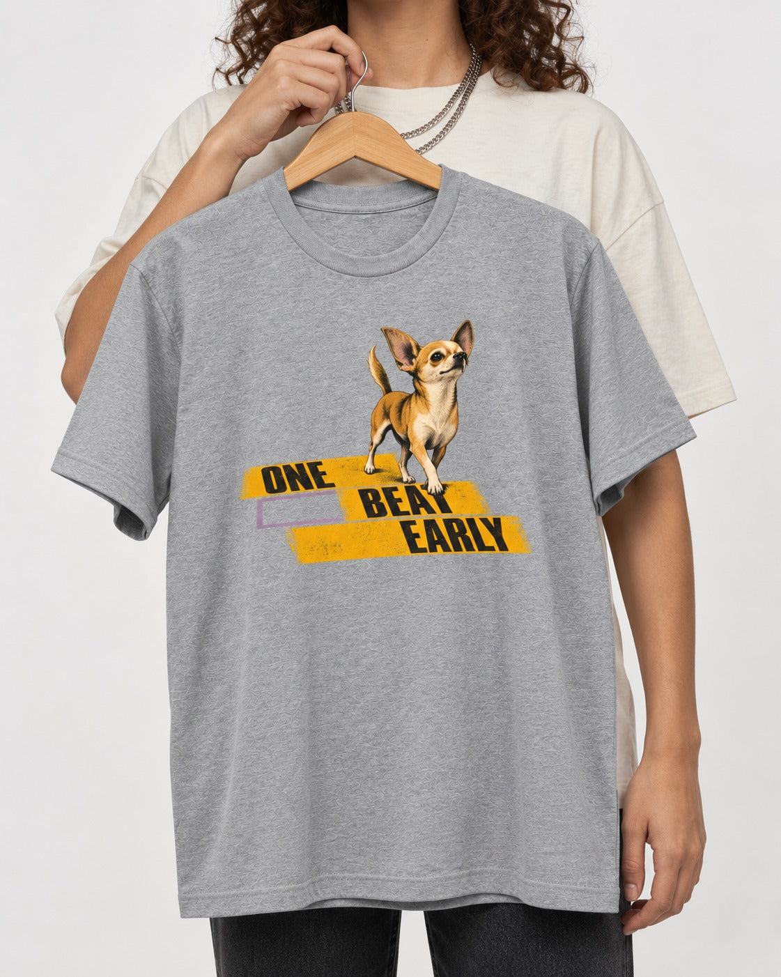 One Beat Early Chihuahua T-Shirt in Sport Grey, held up on a hanger