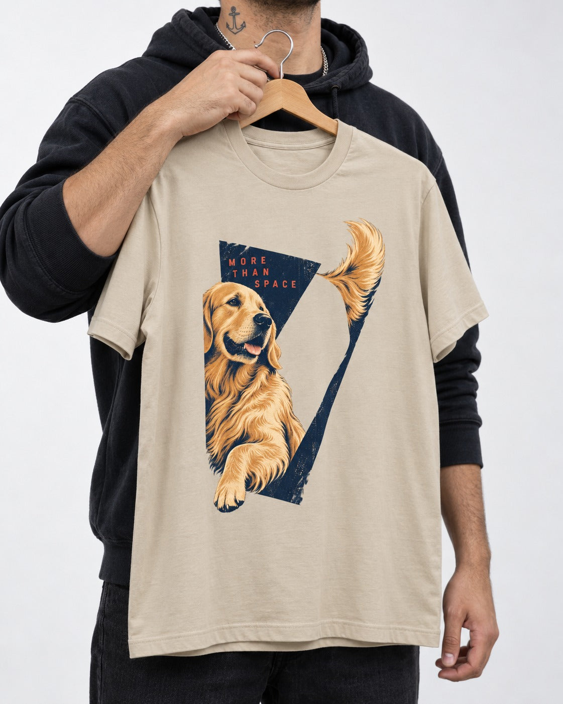 Golden Retriever More Than Space T-Shirt in Sand, held up on a hanger