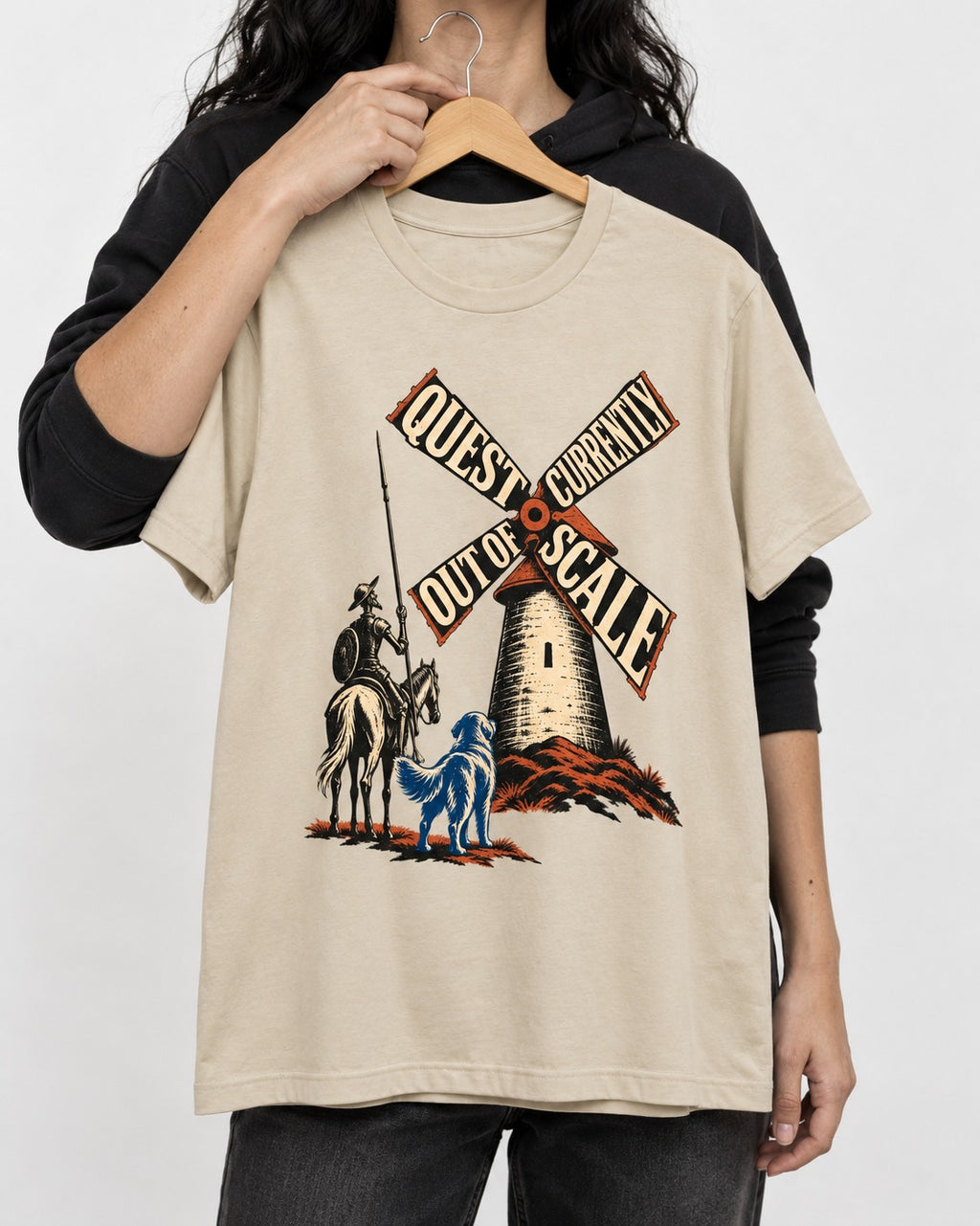 Golden Retriever Quest Out of Scale T-Shirt in Sand, held up on a hanger