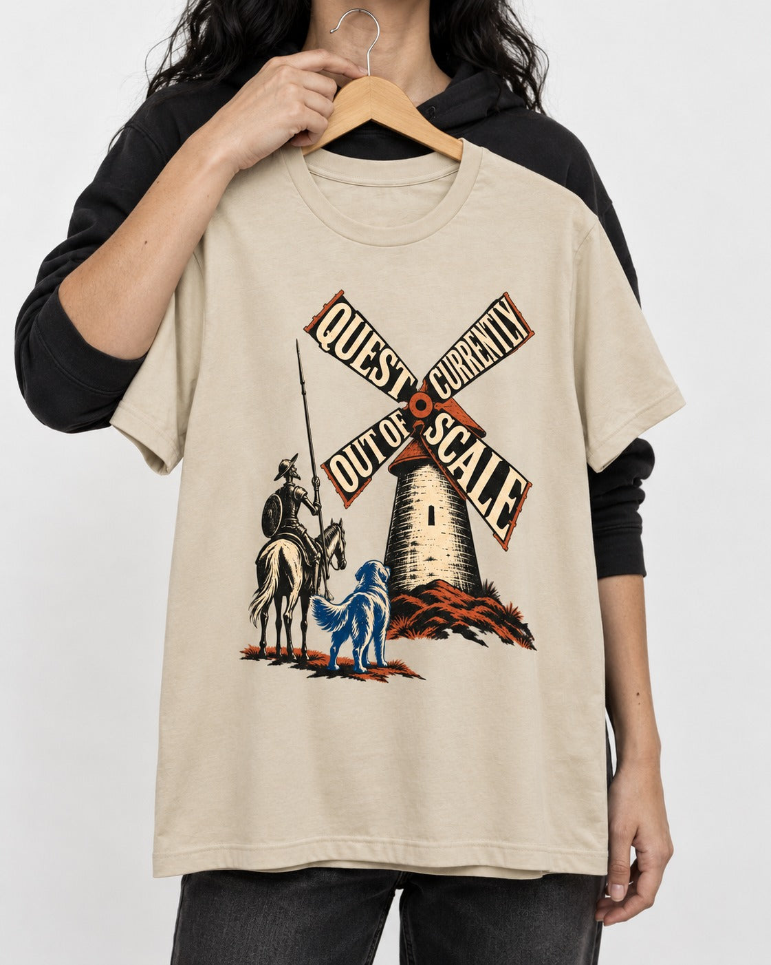 Golden Retriever Quest Out of Scale T-Shirt in Sand, held up on a hanger