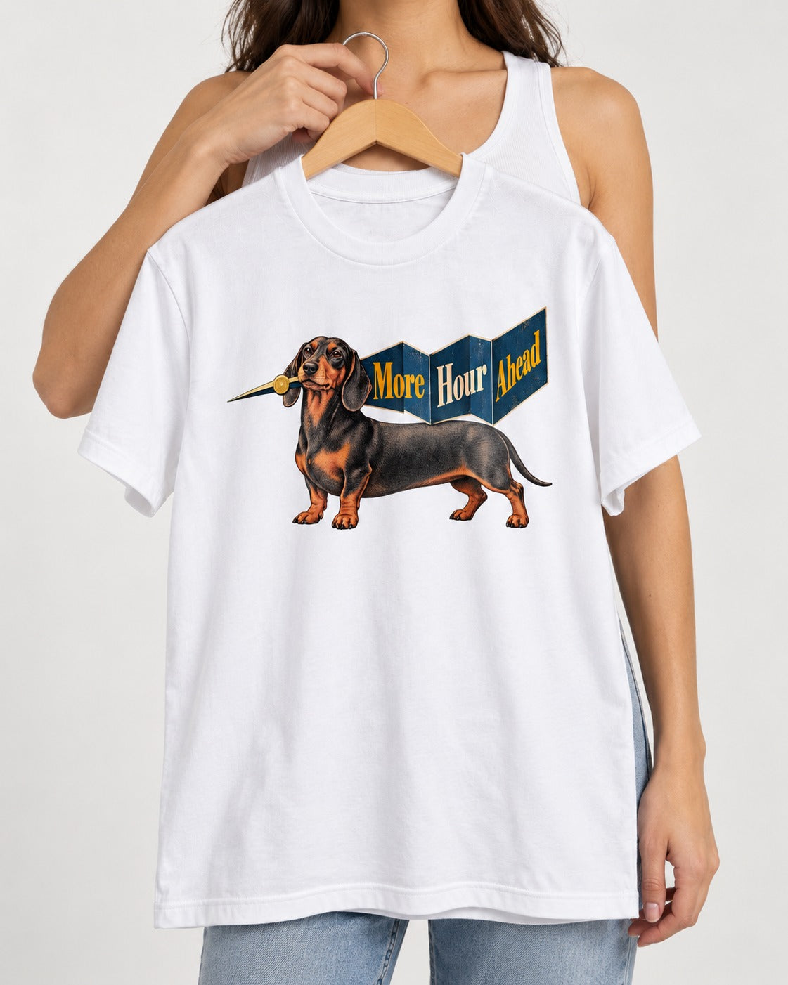Dachshund More Hour Ahead Foldout Banner Graphic T-Shirt in White, held up on a hanger