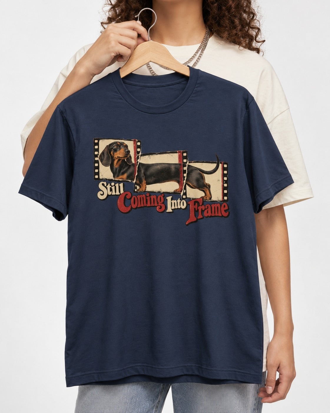 Dachshund Still Coming Into Frame Vintage Filmstrip Graphic T-Shirt in Navy, held up on a hanger