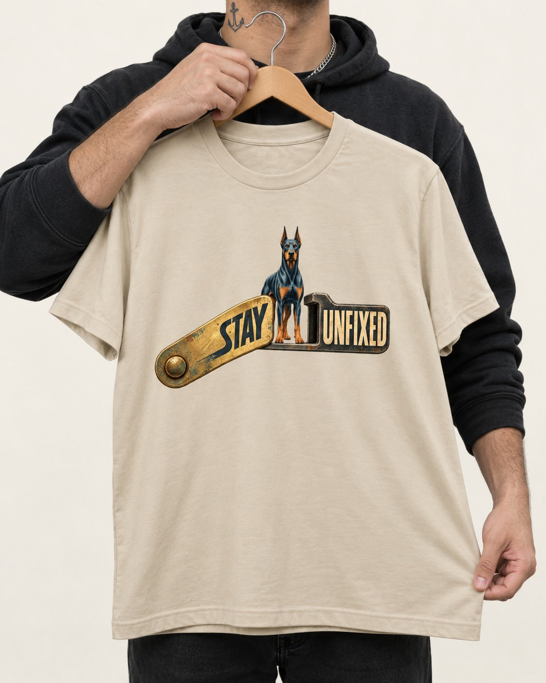 Doberman Stay Unfixed T-Shirt in Sand, held up on a hanger