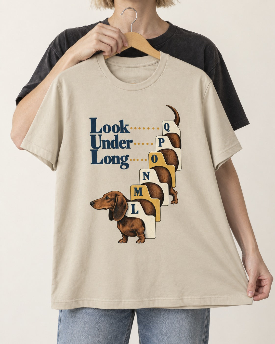 Look Under Long Dachshund T-Shirt in Sand, held up on a hanger