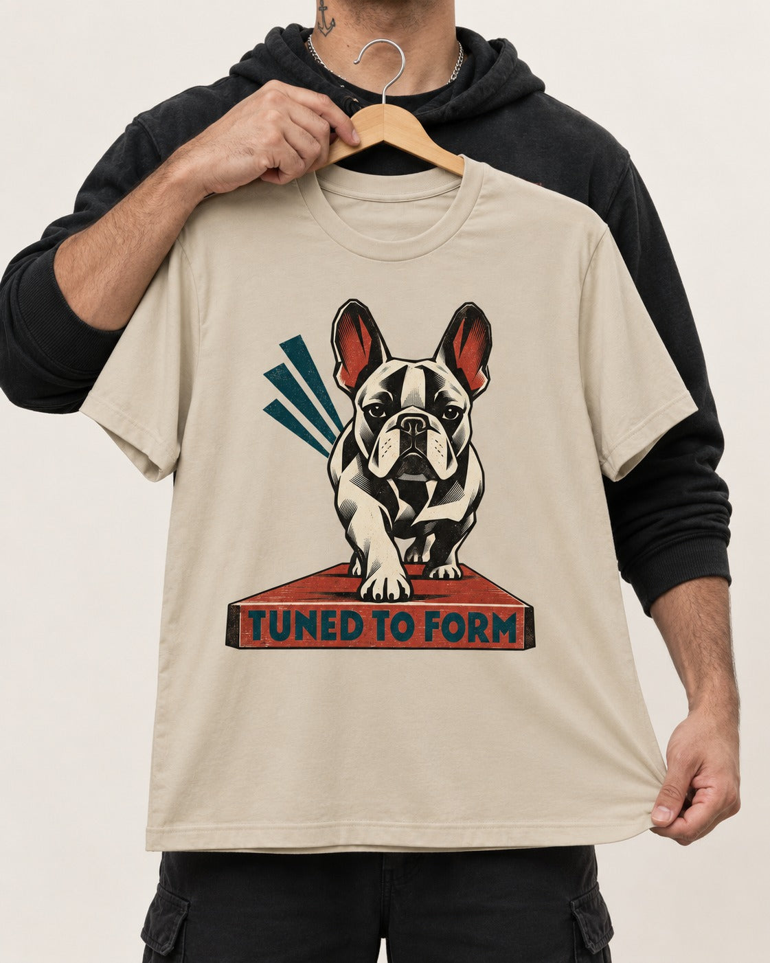 Frenchie Tuned to Form T-Shirt in Sand, held up on a hanger