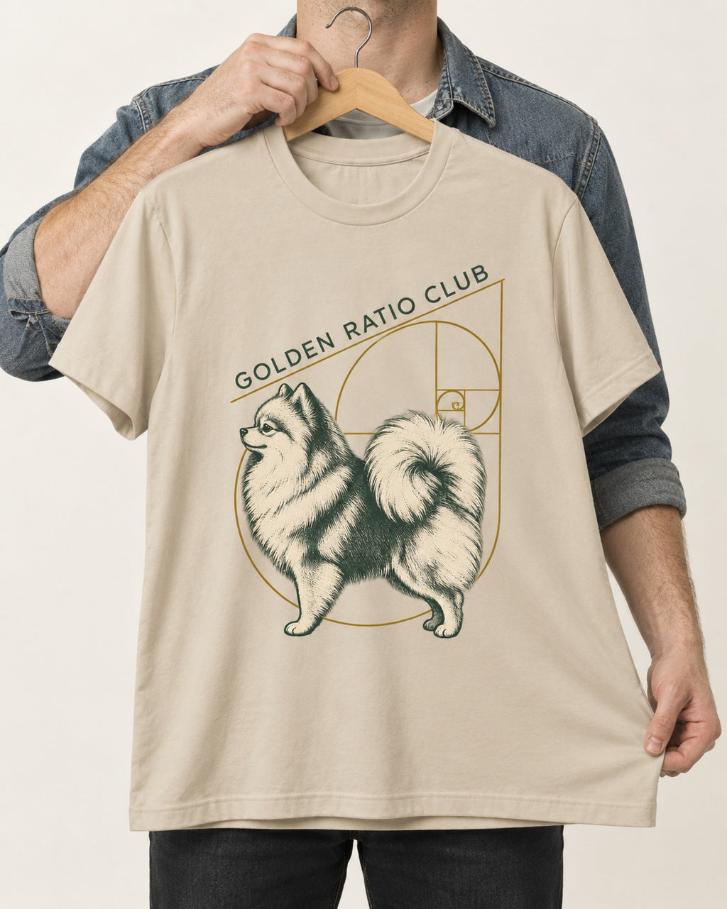 Pomeranian Golden Ratio Club T-Shirt in Sand, held up on a hanger