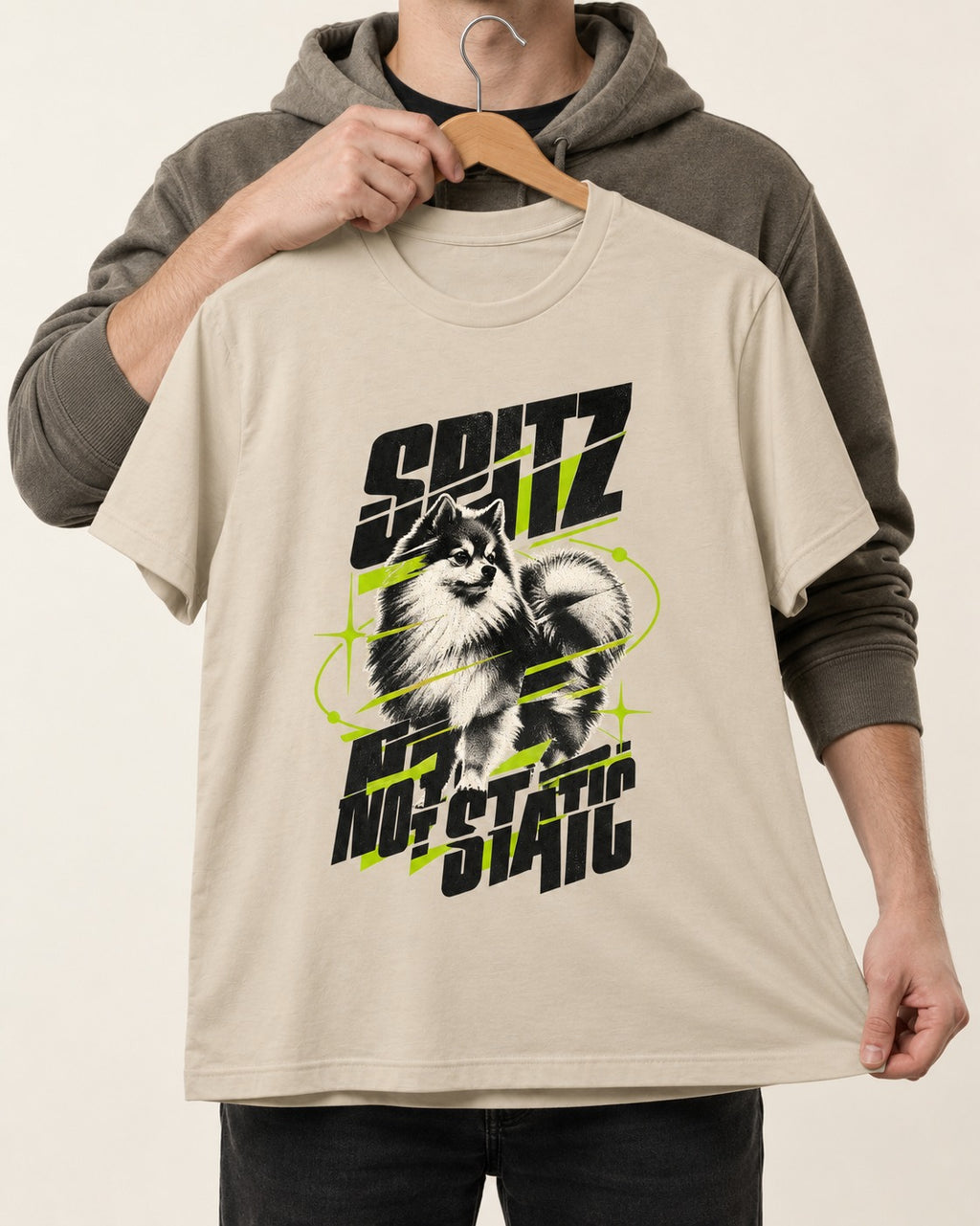 Pomeranian Not Static T-Shirt in Sand, held up on a hanger