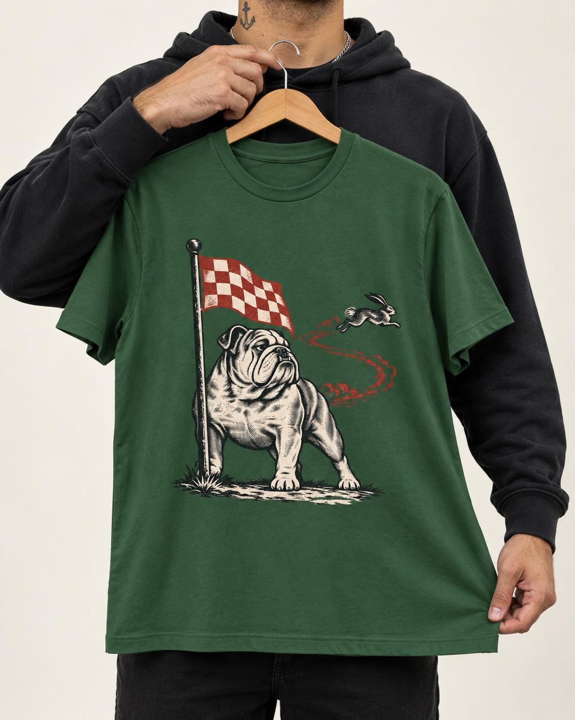 English Bulldog Checkered Flag Rabbit Chase T-Shirt in Forest Green, held up on a hanger