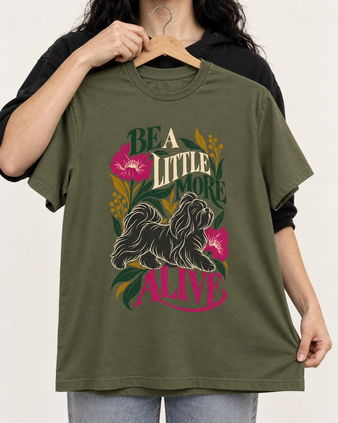 Shih Tzu Be a Little More Alive Botanical Graphic T-Shirt in Heather Military Green, held up on a hanger