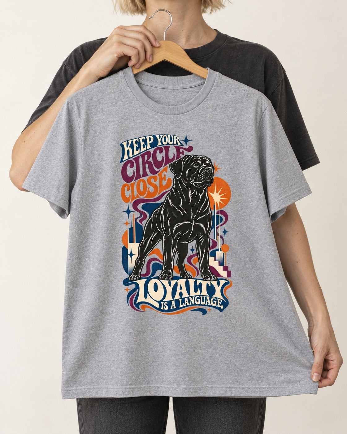 Keep Your Rottweiler Circle Close T-Shirt in Sport Grey, held up on a hanger
