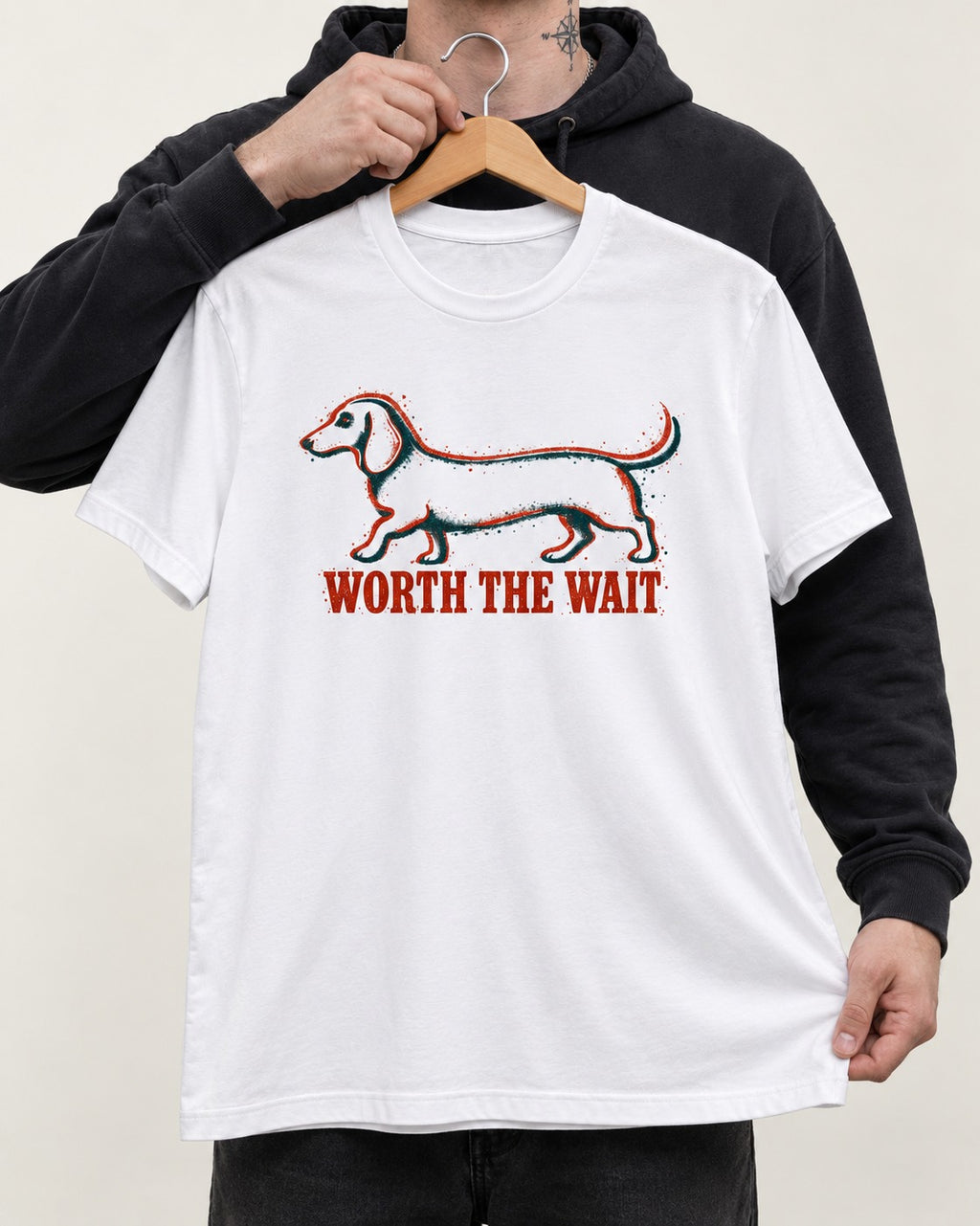 Dachshund Worth The Wait Distressed Outline Graphic T-Shirt in White, held up on a hanger