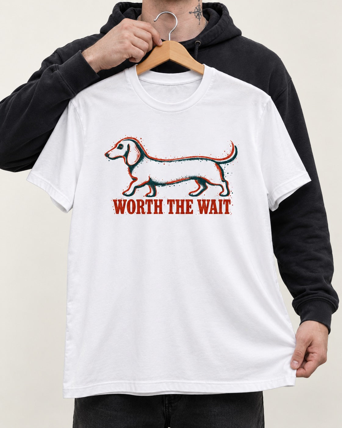 Dachshund Worth The Wait Distressed Outline Graphic T-Shirt in White, held up on a hanger