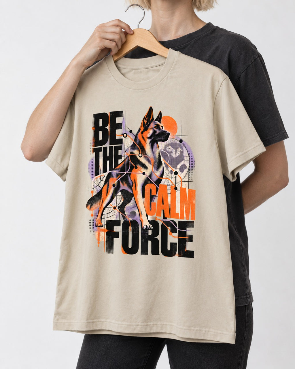 Be the Calm Force German Shepherd Dog T-Shirt in Sand, held up on a hanger
