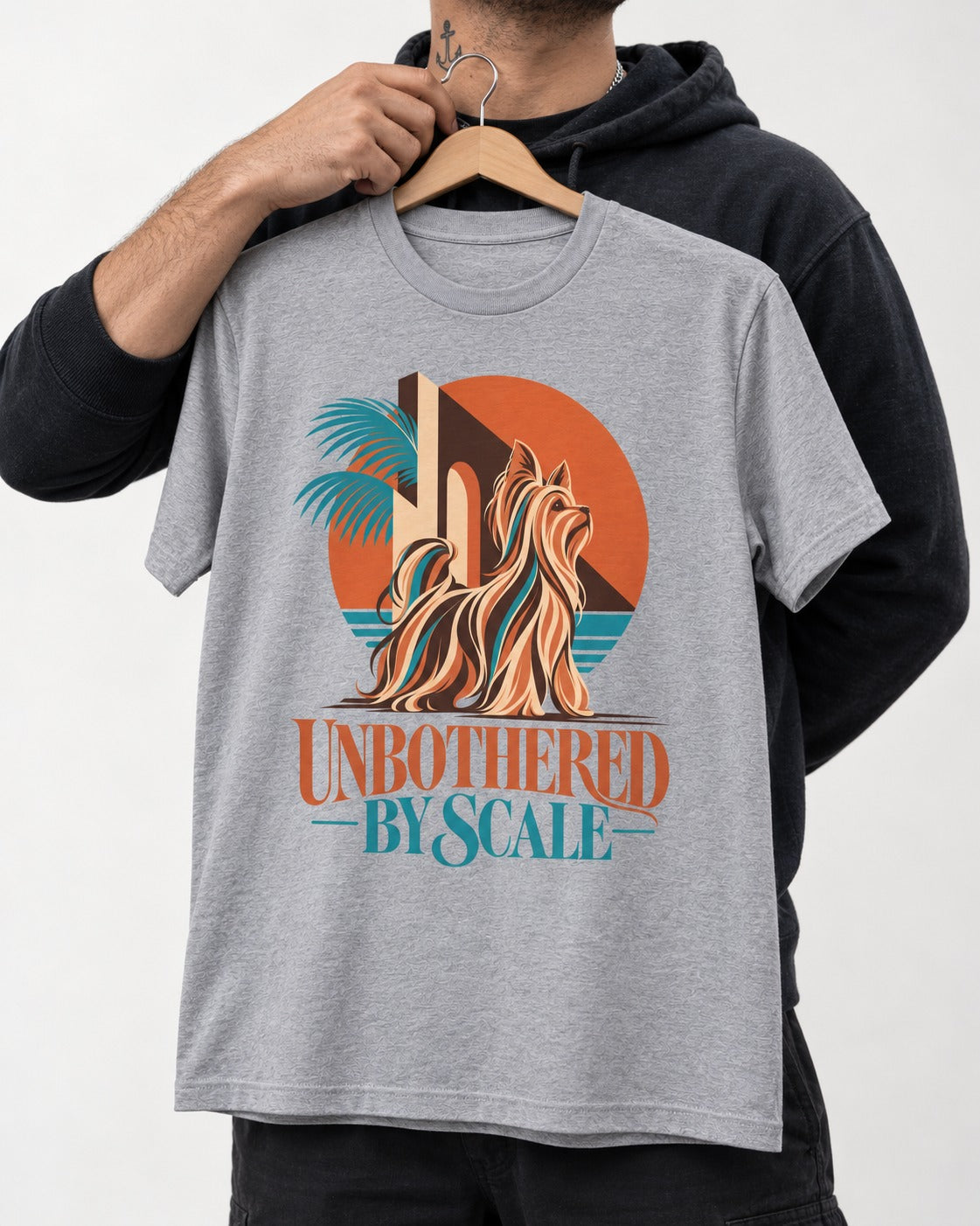 Yorkshire Terrier Unbothered by Scale Tropical Architecture Graphic T-Shirt in Sport Grey, held up on a hanger