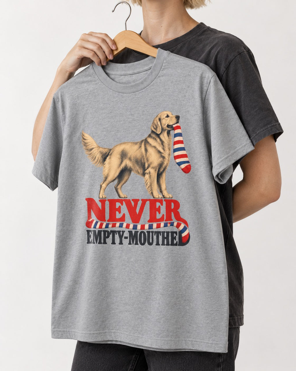 Never Empty Mouthed Golden Retriever T-Shirt in Sport Grey, held up on a hanger