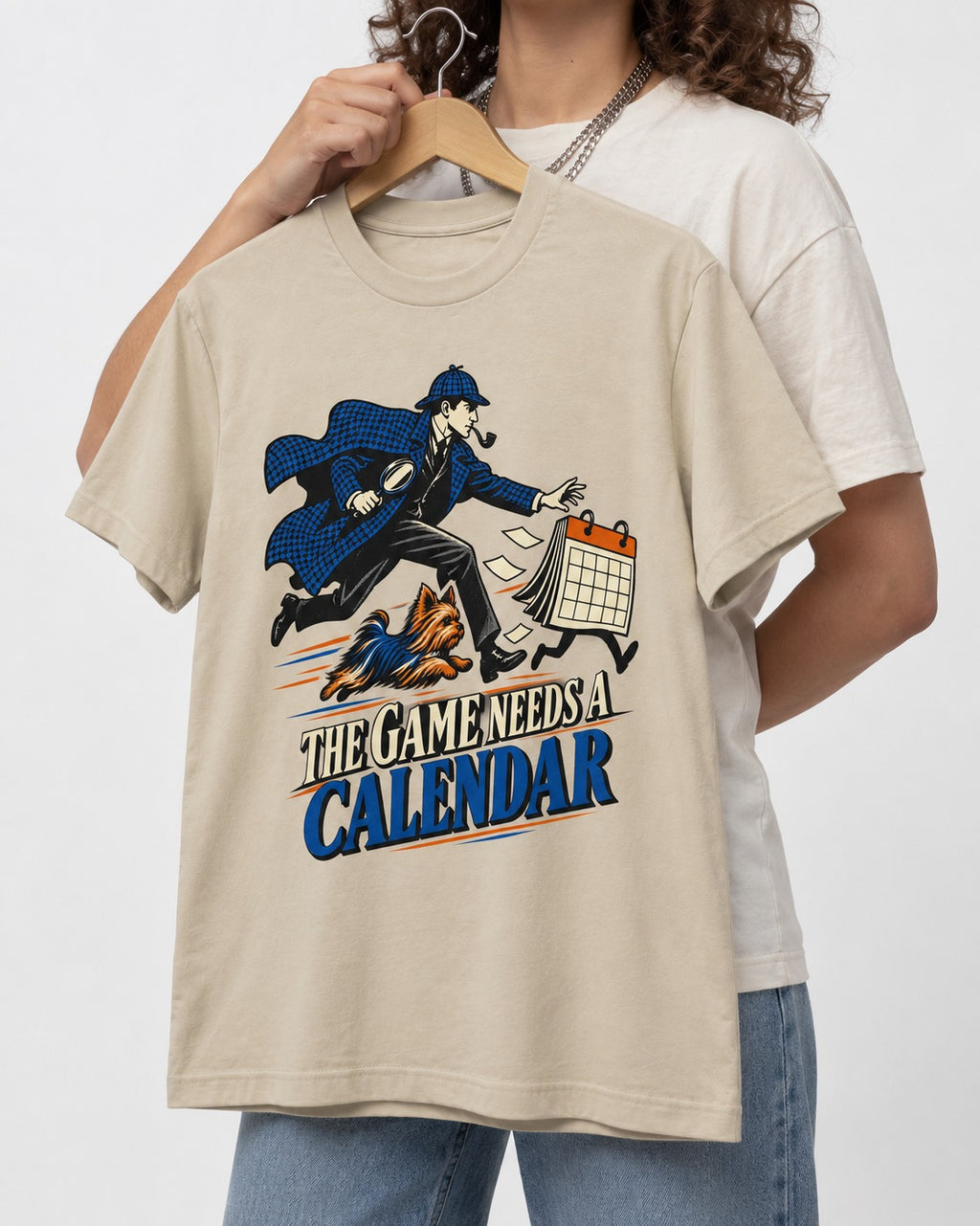 Yorkshire Terrier Game Needs a Calendar T-Shirt in Sand, held up on a hanger