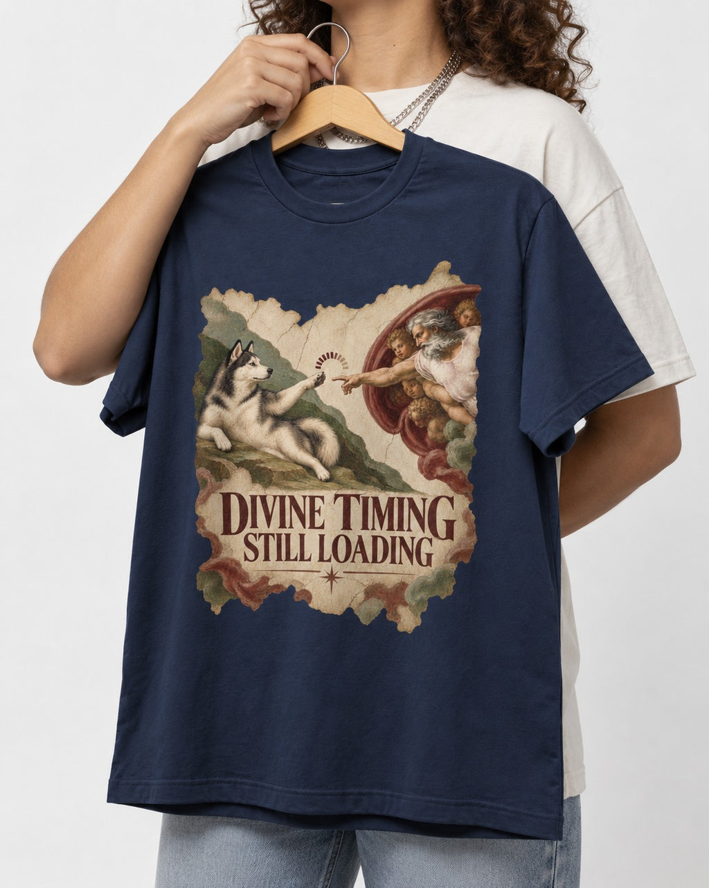 Husky Divine Timing Still Loading Creation Parody Graphic T-Shirt in Navy, held up on a hanger