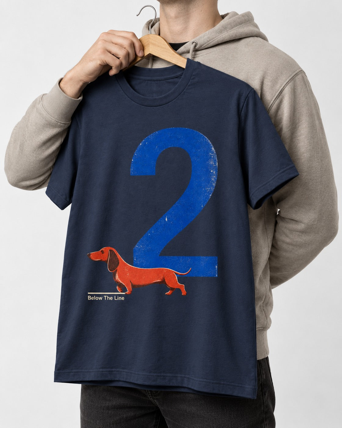 Dachshund Below The Line Number Two Graphic T-Shirt in Navy, held up on a hanger