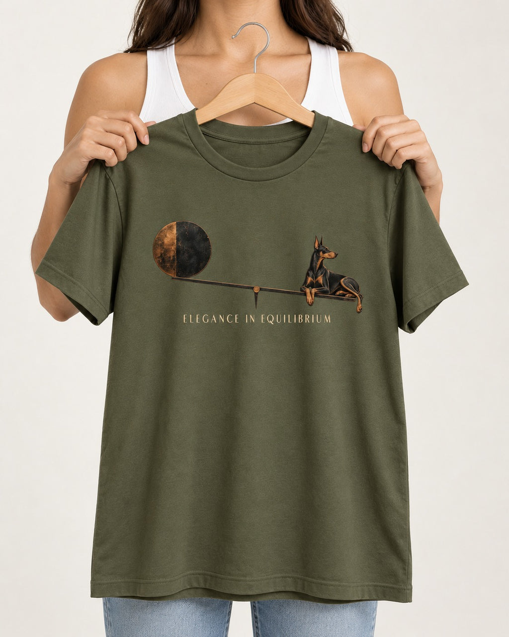 Doberman Elegance in Equilibrium Balance Graphic T-Shirt in Heather Military Green, held up on a hanger