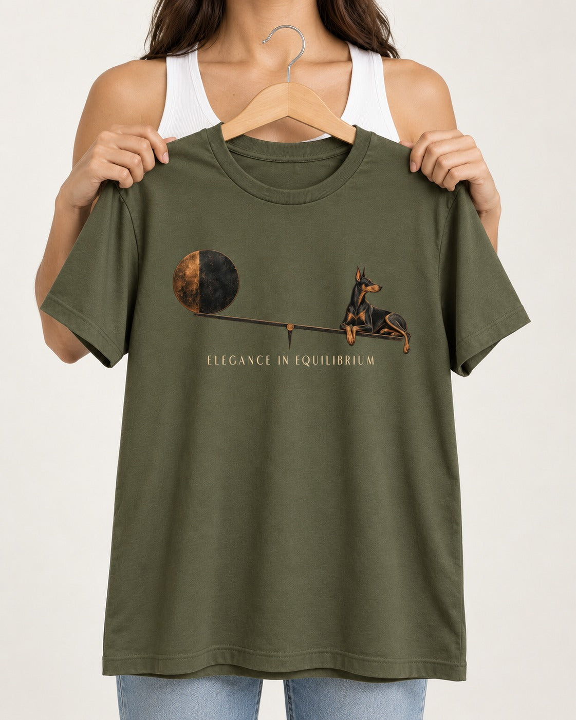 Doberman Elegance in Equilibrium Balance Graphic T-Shirt in Heather Military Green, held up on a hanger