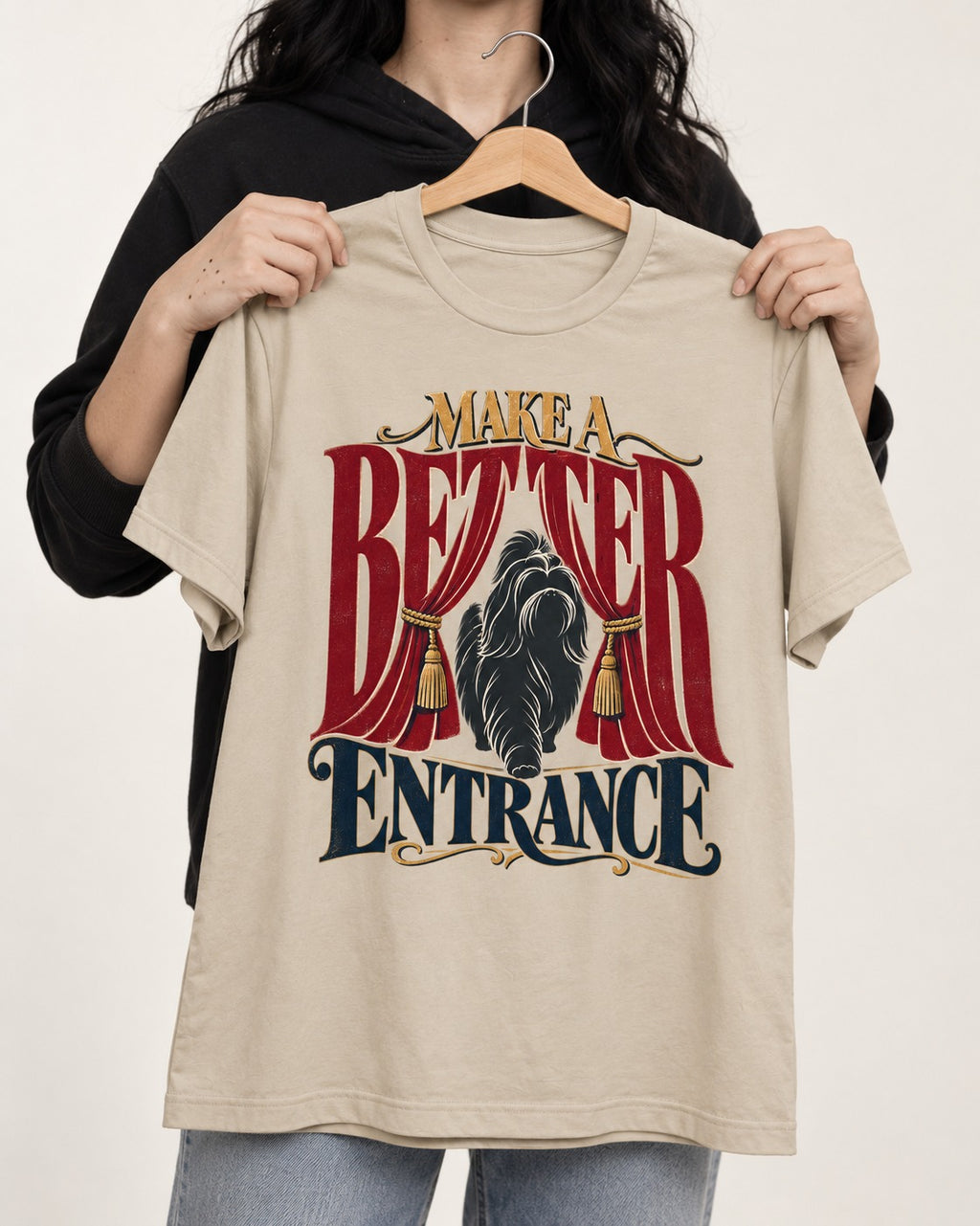 A Better Shih Tzu Entrance T-Shirt in Sand, held up on a hanger