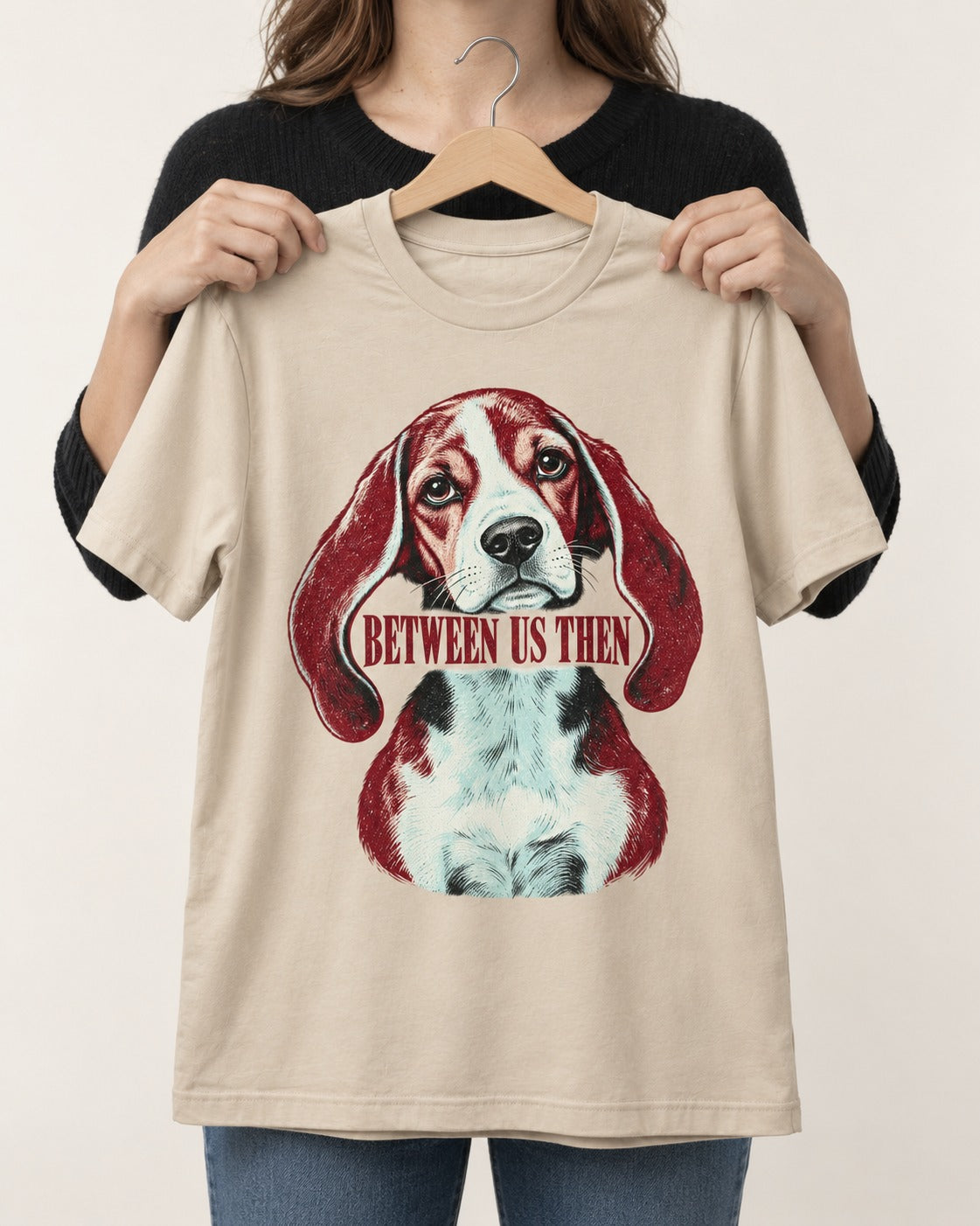 Beagle Between Us Then T-Shirt in Sand, held up on a hanger