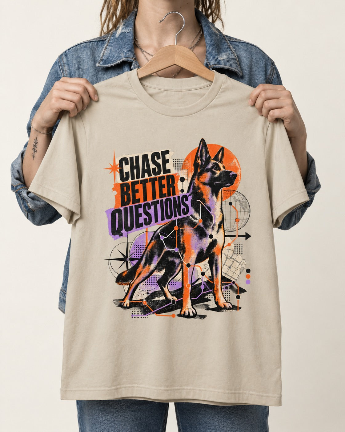 Chase Better Questions German Shepherd Dog T-Shirt in Sand, held up on a hanger