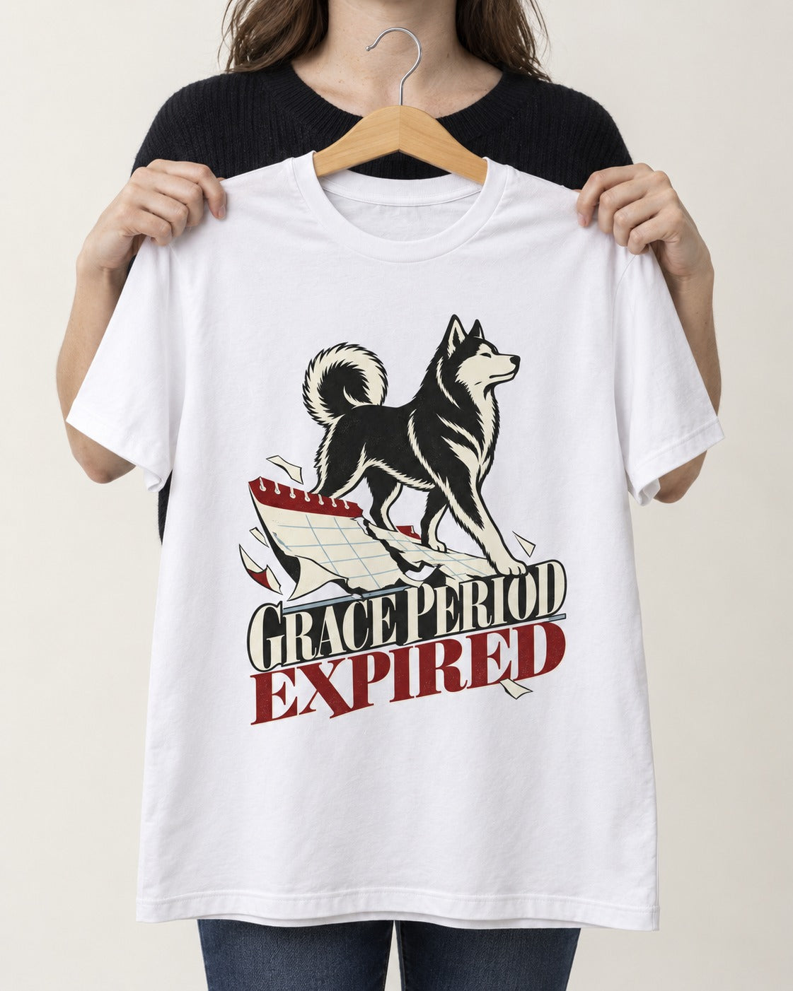 Husky Grace Period Expired Torn Calendar Graphic T-Shirt in White, held up on a hanger