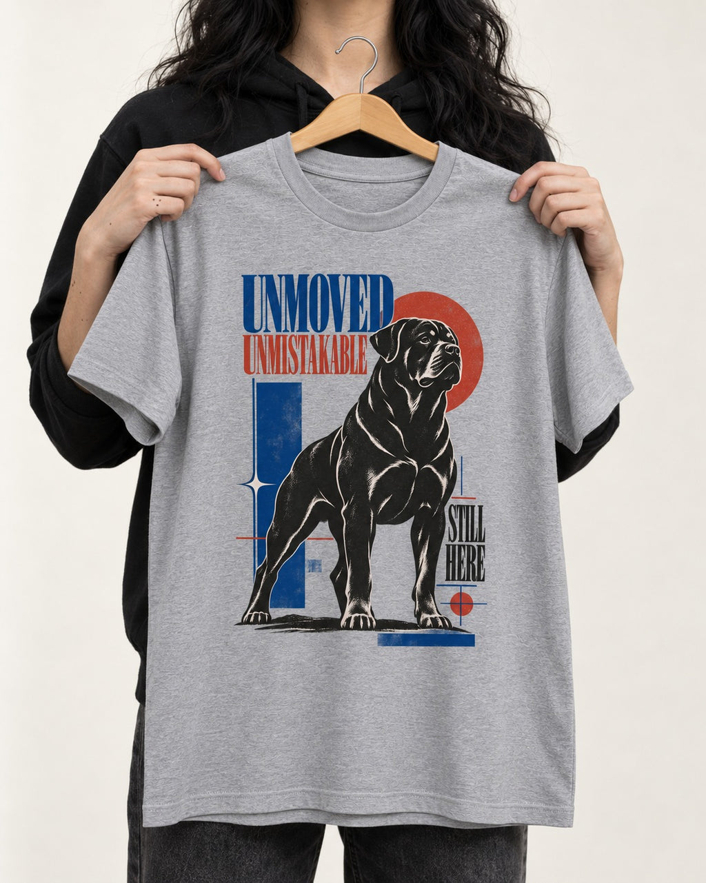 Unmoved Unmistakable Rottweiler T-Shirt in Sport Grey, held up on a hanger