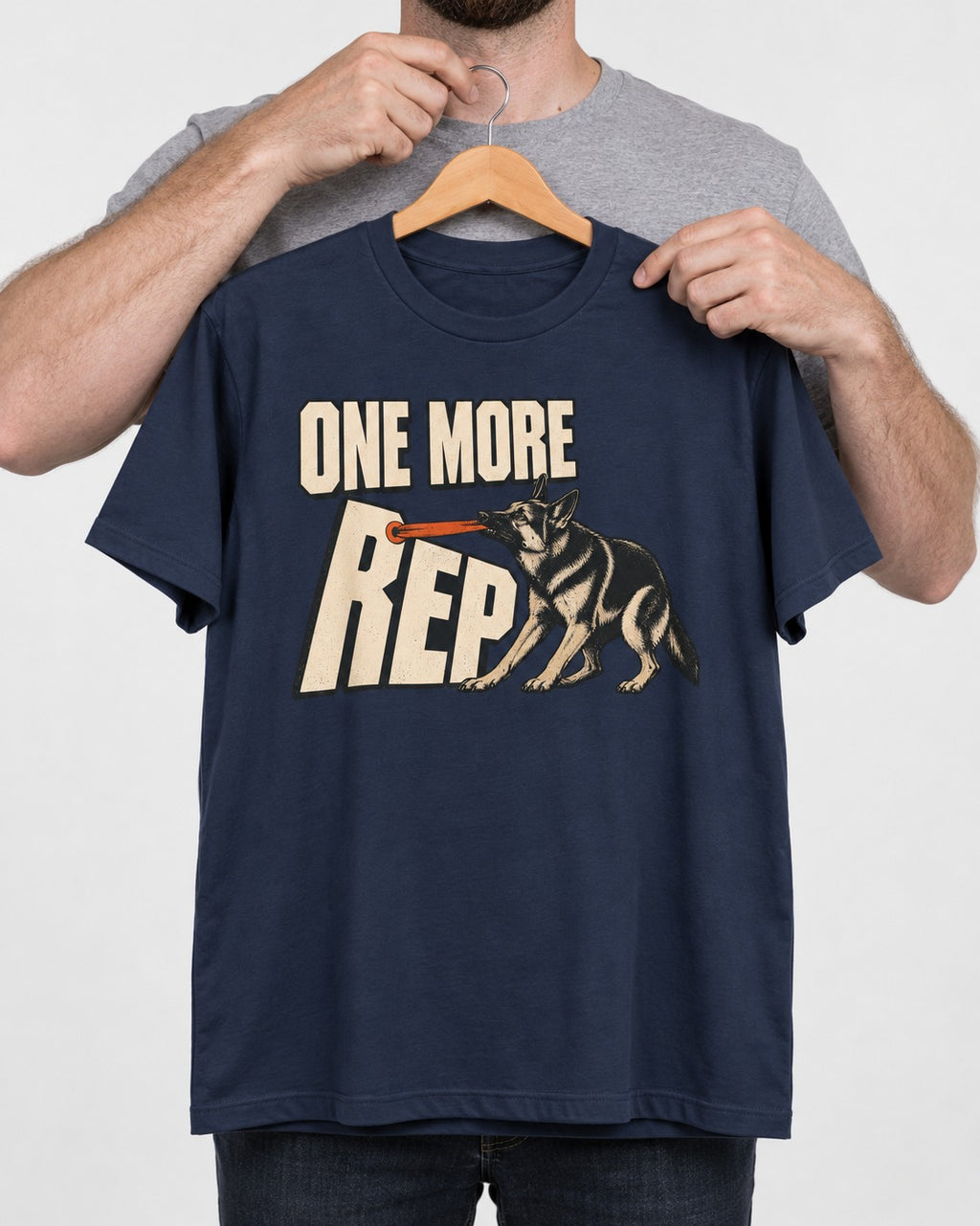 One More Rep Tug German Shepherd Dog Graphic T-Shirt in Navy, held up on a hanger