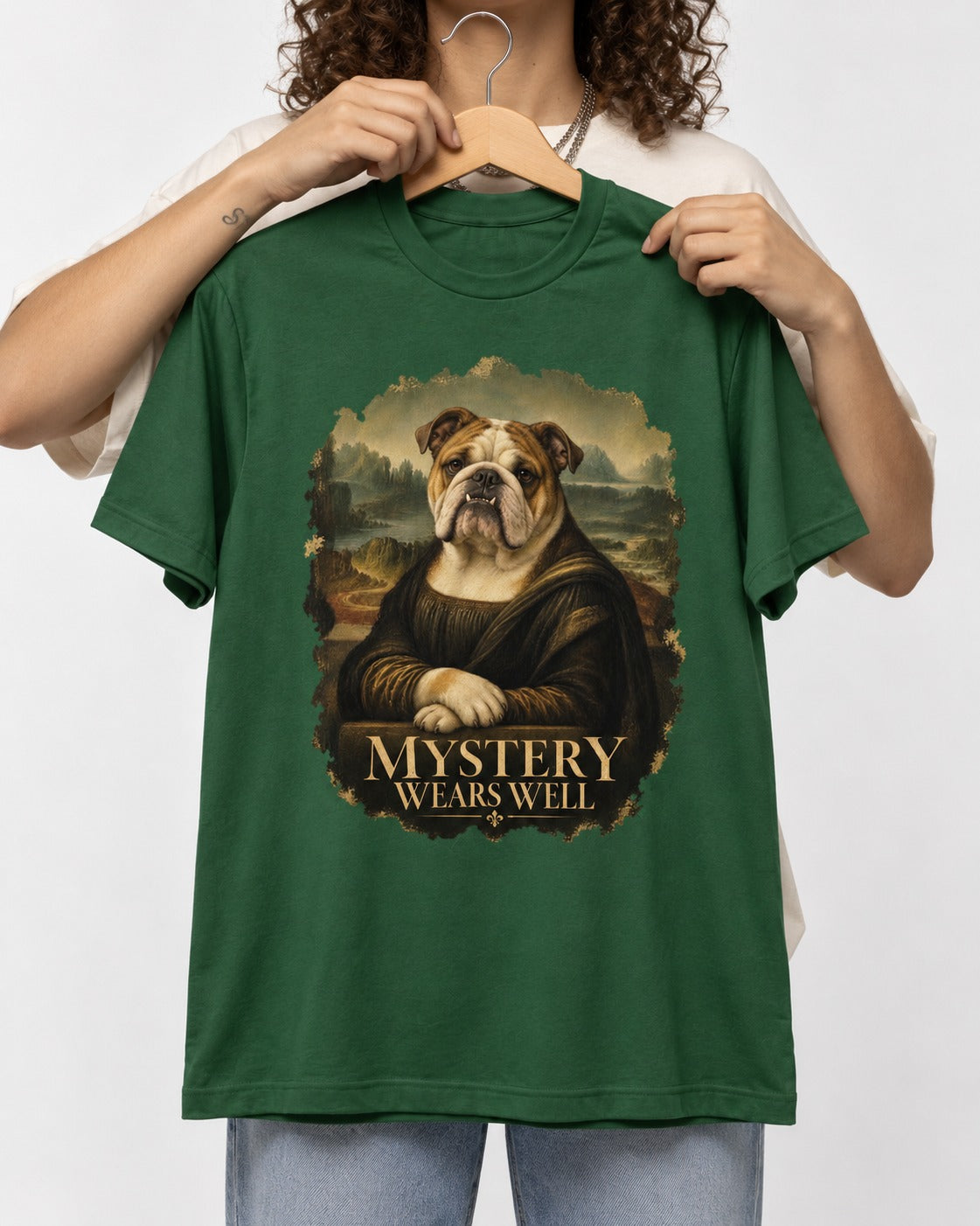 English Bulldog Mystery Wears Well Mona Lisa Portrait T-Shirt in Forest Green, held up on a hanger