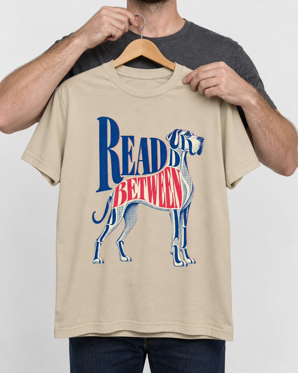 Read Between the Lines Great Dane T-Shirt in Sand, held up on a hanger
