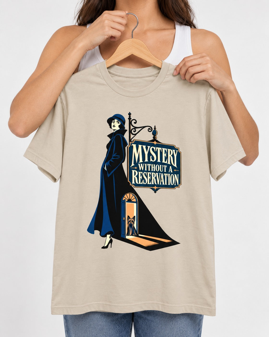 Mystery Without a Reservation Yorkshire Terrier T-Shirt in Sand, held up on a hanger