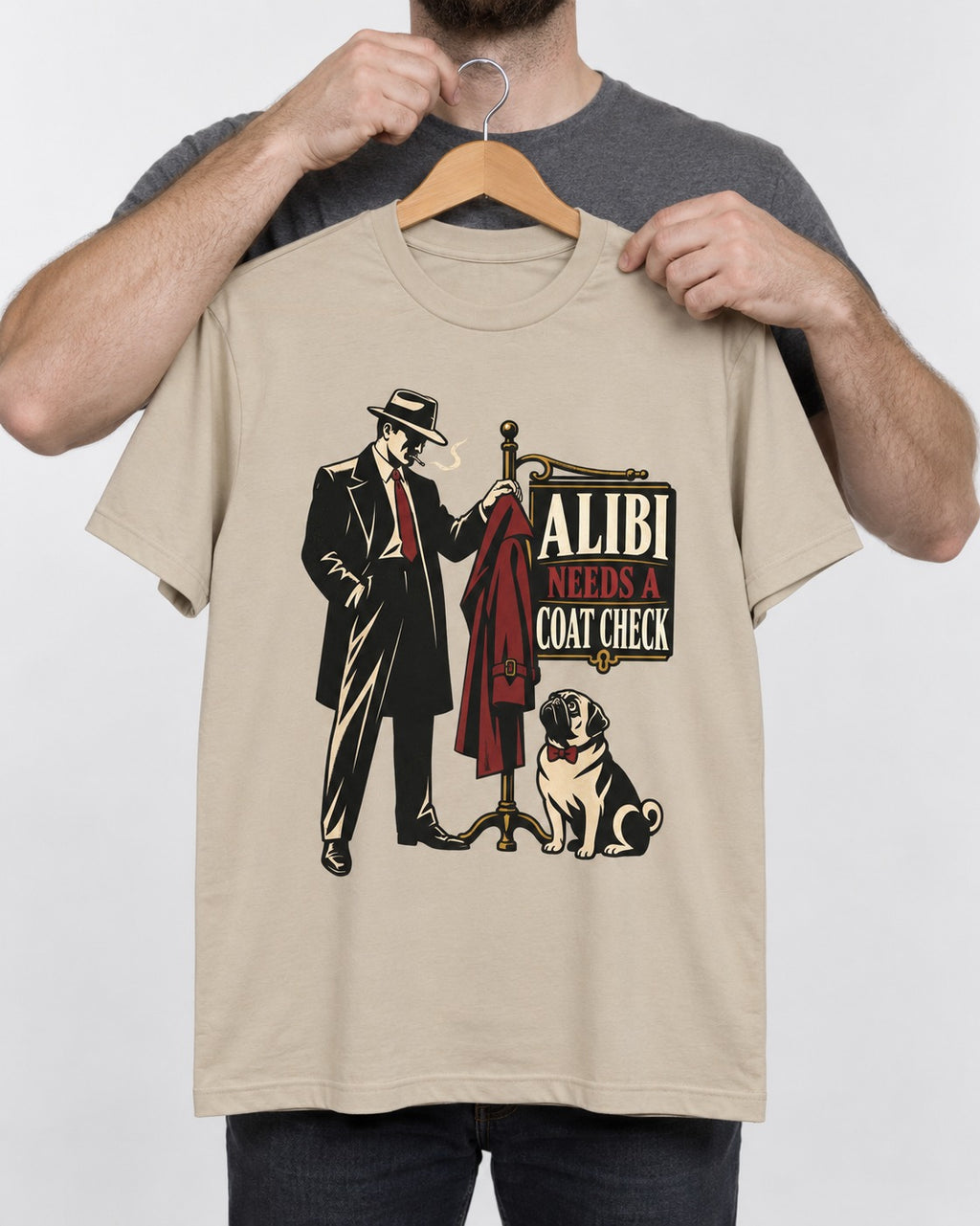 Pug Alibi Needs Coat Check T-Shirt in Sand, held up on a hanger